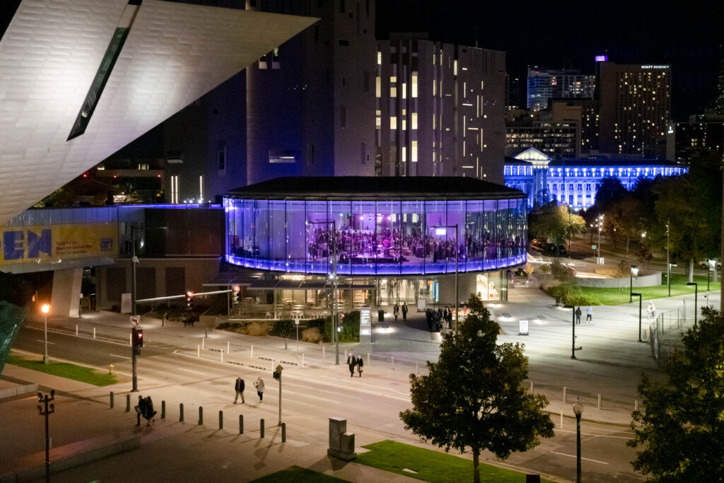 Denver Art Museum’s Sturm Grand Pavilion at night, lit for an evening event — illustrating the real cost of event day-of changes. Photo © Andy Colwell, 2020.