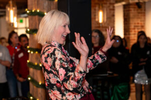 woman celebrating with her work family at a venue